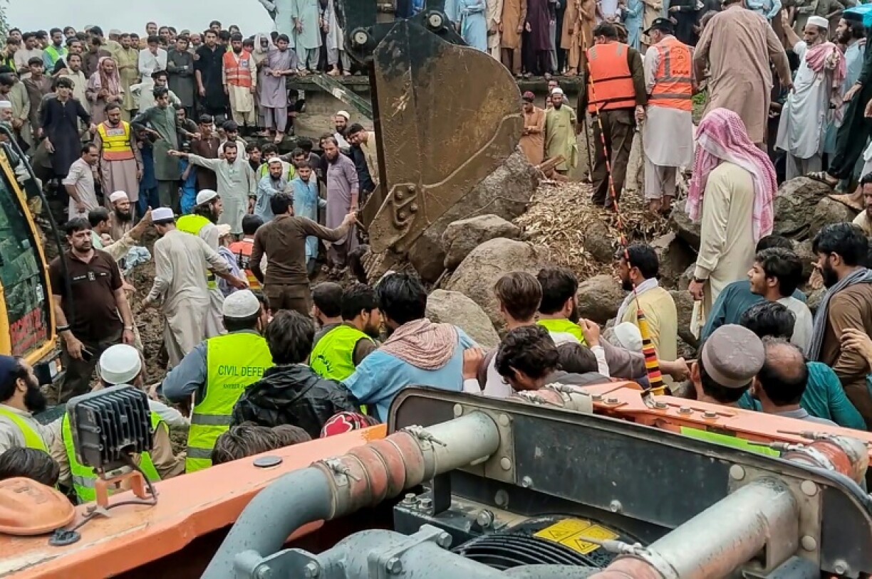Rescuers search for victims at the site of a flash flood in Pakistan's Bajaur district