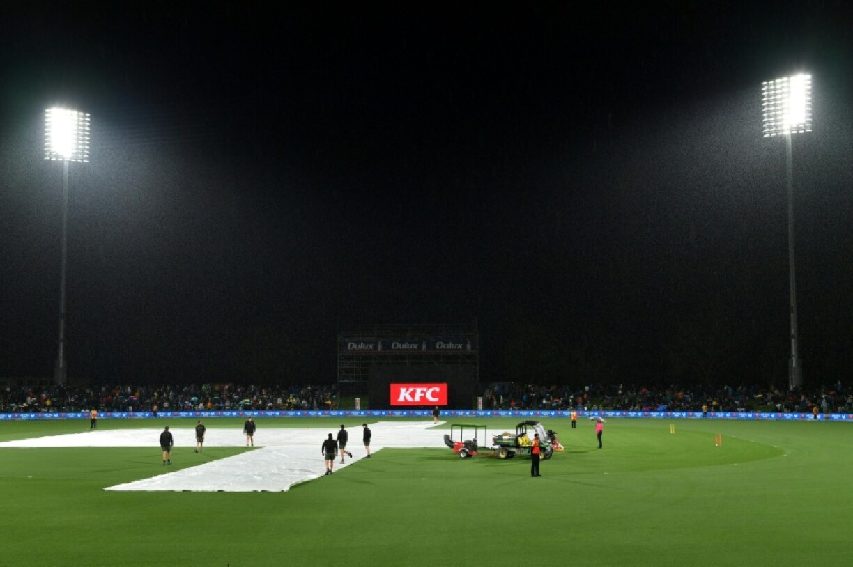 A general view shows the covers on the pitch as rain delays the first Twenty20 international cricket match between New Zealand and England at Hagley Oval in Christchurch on October 18, 2025.