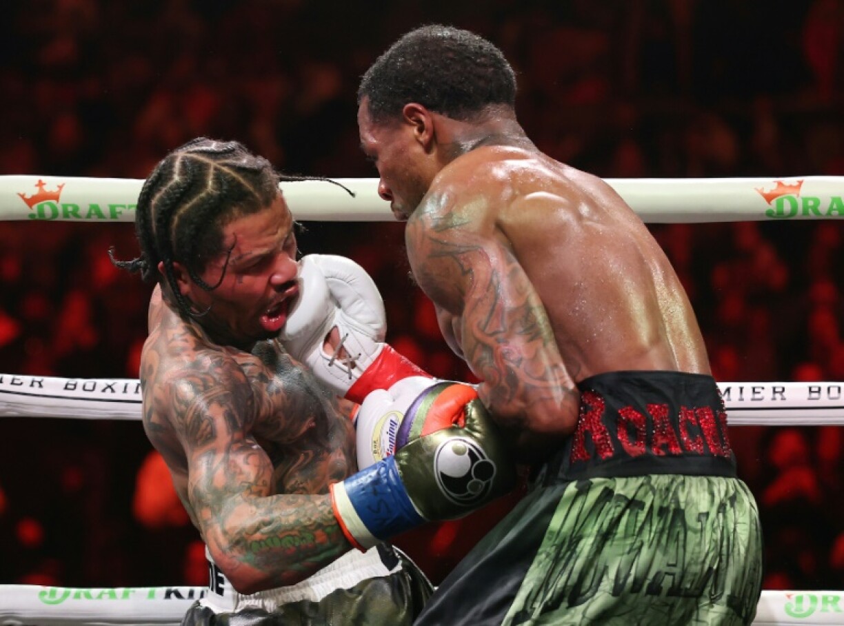 Lamont Roach punches Gervonta Davis during their bout for Davis' WBA lightweight world title in Brooklyn