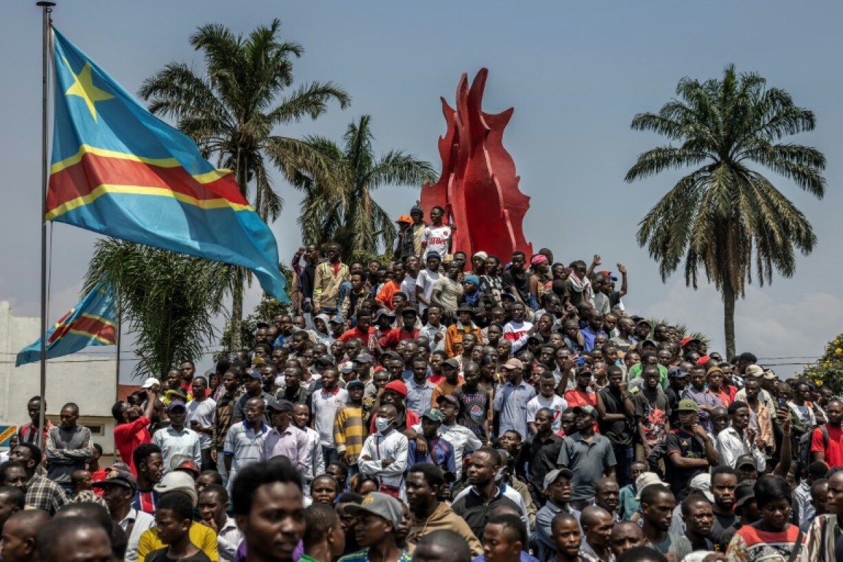 People in the eastern DR Congo city of Bukavu gather after a rally organised by civil society groups in support of the M23 movement