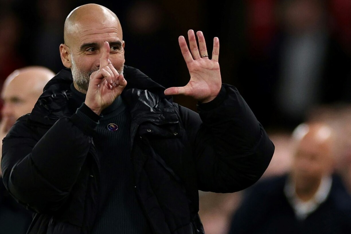 Manchester City manager Pep Guardiola reacts to Liverpool fans