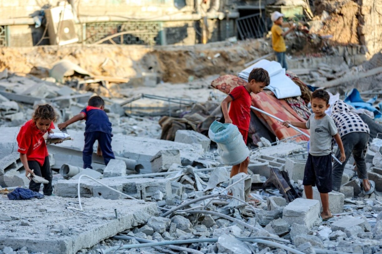 Children search through rubble in Gaza City