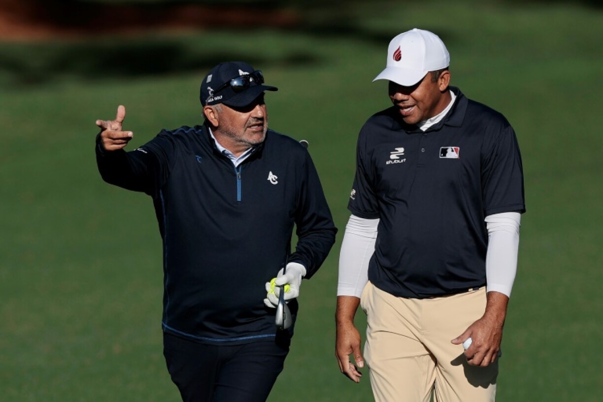 Argentina's Angel Cabrera, left, and Venezuela's Jhonattan Vegas talk during a practice round for the 89th Masters, which past champion Cabrera was invited to play despite serving a 30-month prison sentence for domestic violence