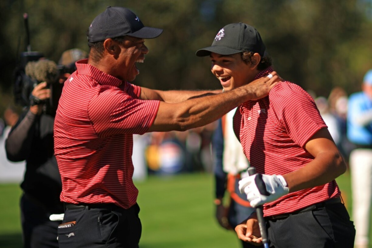 Tiger Woods reacts with son Charlie Woods after Charlie's hole-in-one at the PNC Championship