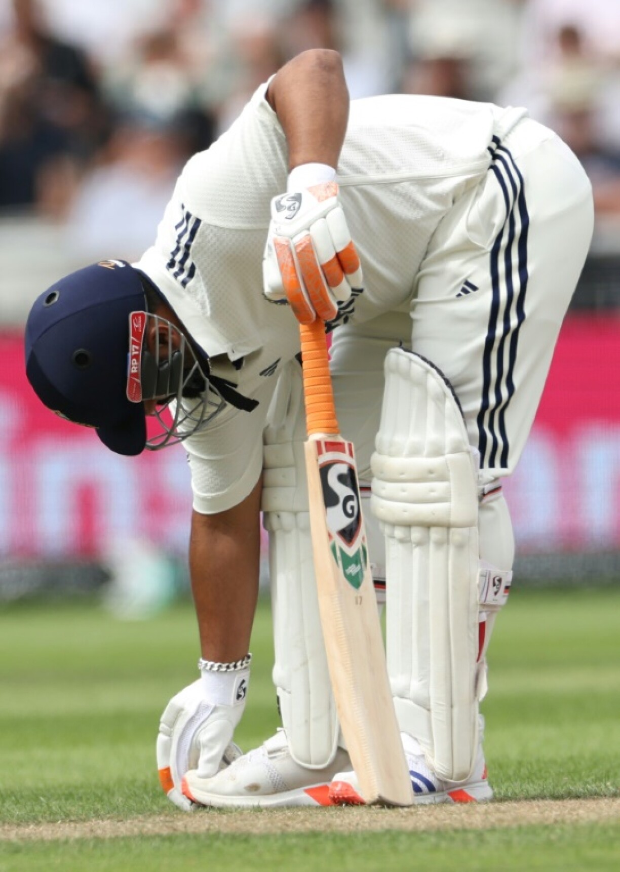 India's Rishabh Pant feels his injured foot during the fourth Test against England at Old Trafford