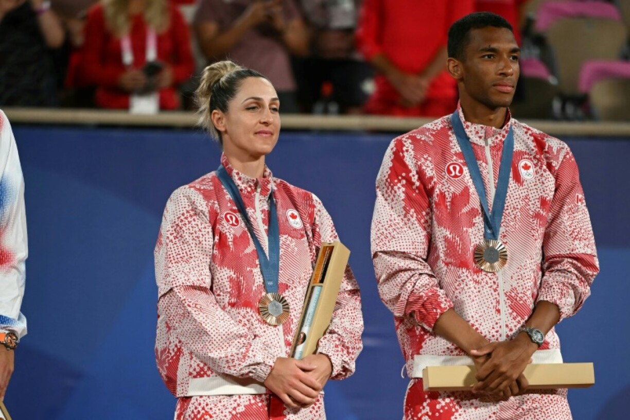 Olympic mixed doubles tennis bronze medallists Gabriela Dabrowski and Felix Auger-Aliassime of Canada pose on the podium at the 2024 Paris Olympics