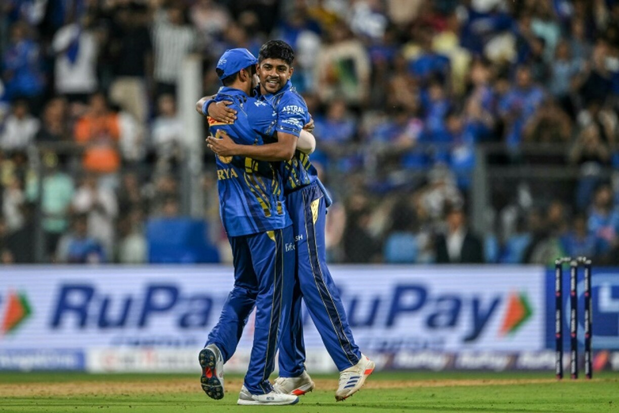 Breakthrough: Mumbai Indians' Ashwani Kumar (R) celebrates with Suryakumar Yadav after taking the wicket of Kolkata Knight Riders' Rinku Singh