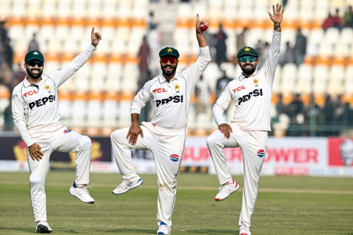 Pakistan's chief wicket-taker Sajid Khan celebrates with Mohammad Rizwan and Babar Azam after beating West Indies by 127 runs in the first cricket Test in Multan