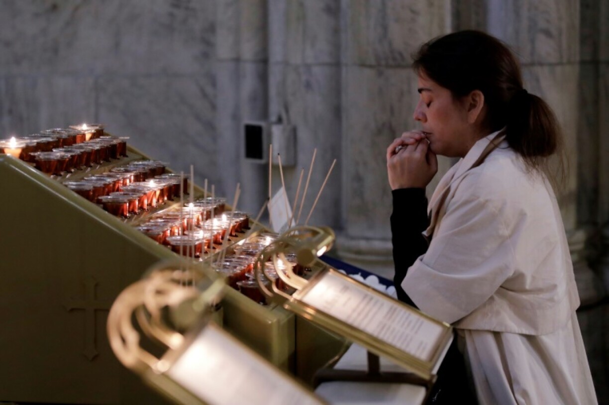 A woman prays at St. Patrick's Cathedral in New York following the selection of Pope Leo XIV