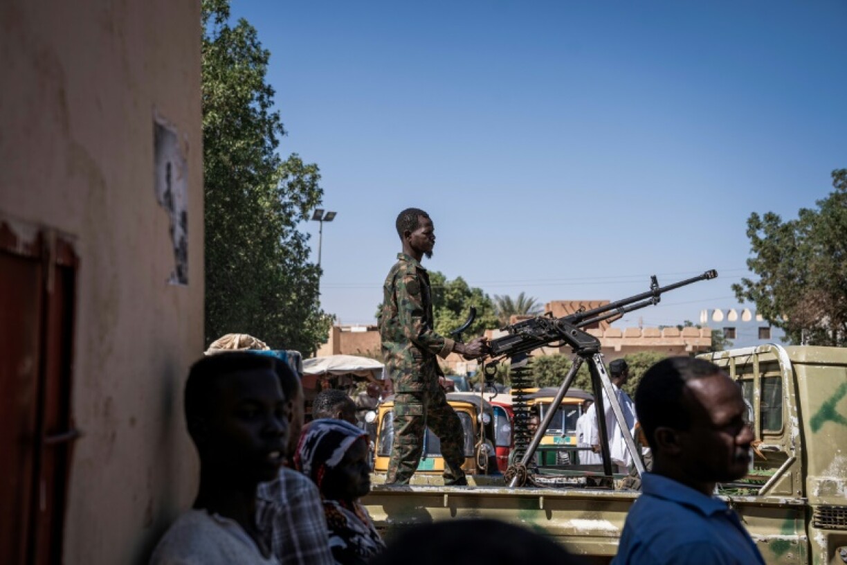 (FILES) A Sudanese army soldier mans a machine gun on top of a military pickup truck outside a hospital in Omdurman