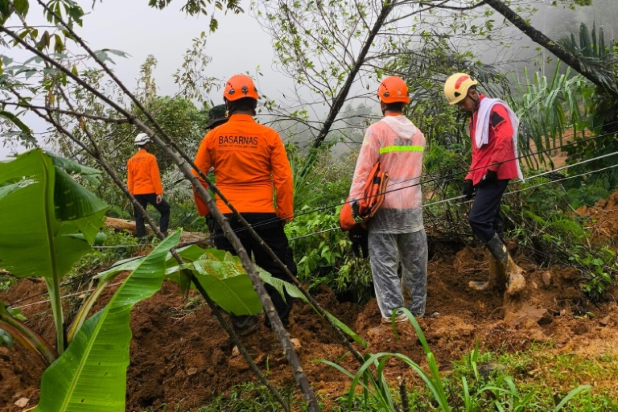 Rescuers at the site of a landslide triggered by heavy rain near Pekalongan city in Indonesia's Central Java province