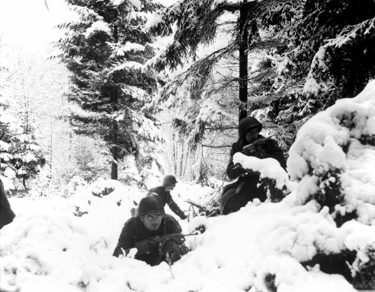 American infantrymen of the 290th Regiment fight in fresh snowfall near Amonines, Belgium