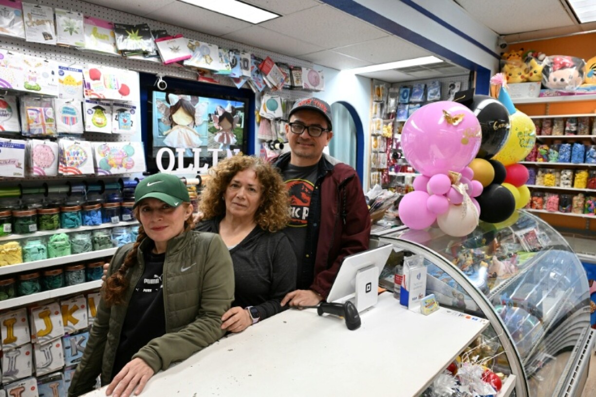 Patricia Loperena (L) poses for a photo with family members at their Ollin Party Store in the San Fernando Valley area of Los Angeles, where they are starting to feel the sting from Donald Trump's tariffs