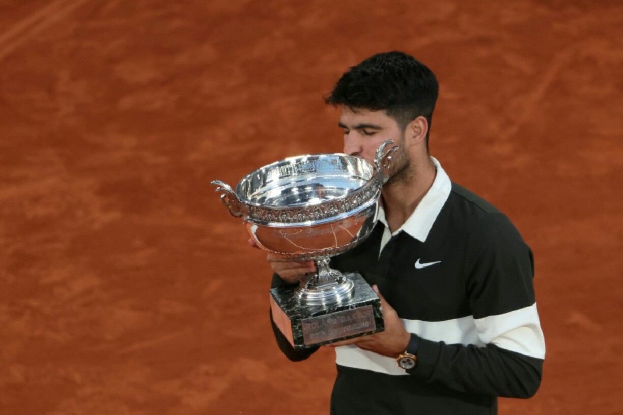 Carlos Alcaraz kisses the Coupe des Mousquetaires after scraping past Jannik Sinner in a thrilling Roland Garros final