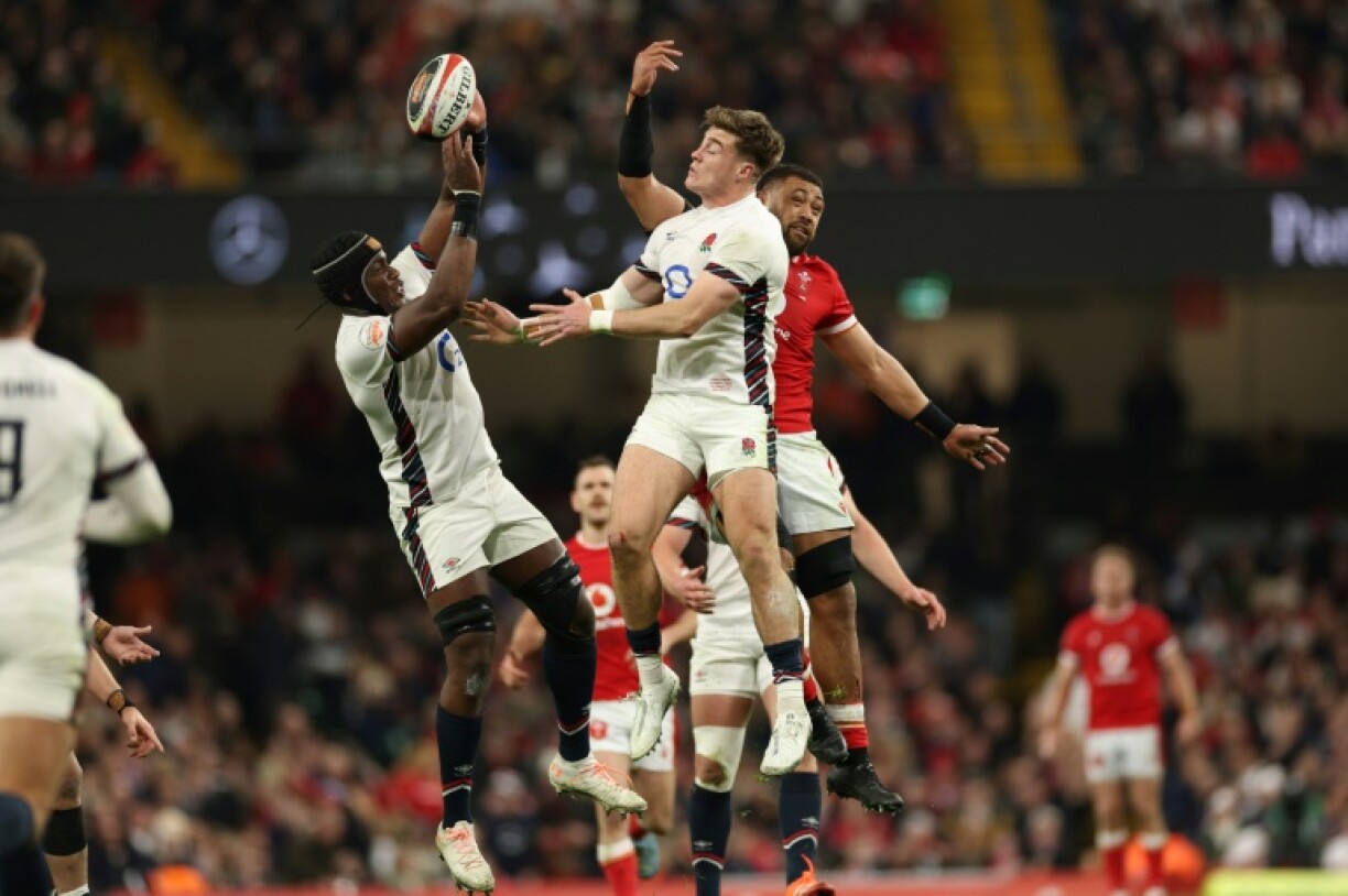 High flyer: England centre Tommy Freeman (C) competes for a high ball alongside England captain Maro Itoje (L) and against Wales No 8 Taulupe Faletau (R) in Cardiff