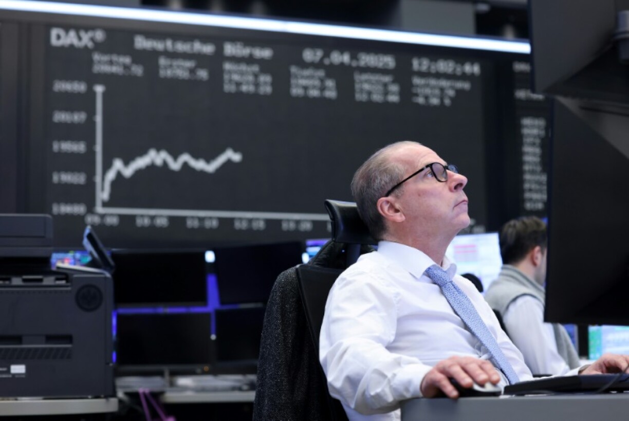 A trader at the stock exchange in Frankfurt, which clawed back some ground after heavy losses