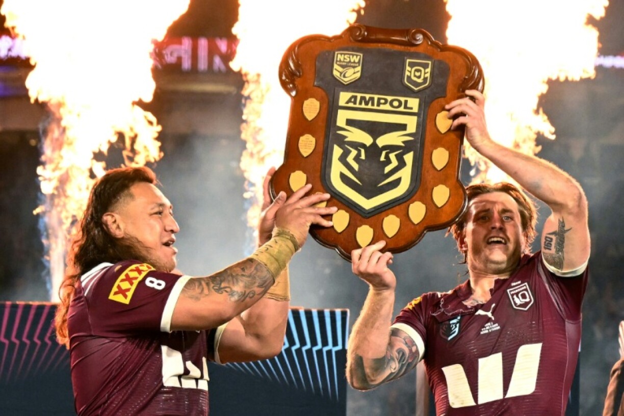 Queensland's Josh Papalii (left) and captain Cameron Munster lift the trophy after winning the State of Origin