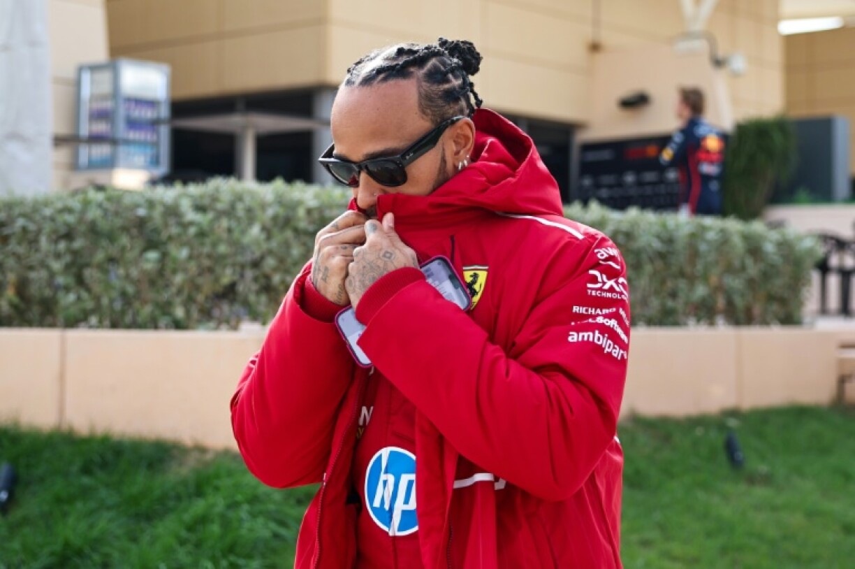 Lewis Hamilton makes his way to his new Ferrari garage on the first day of testing