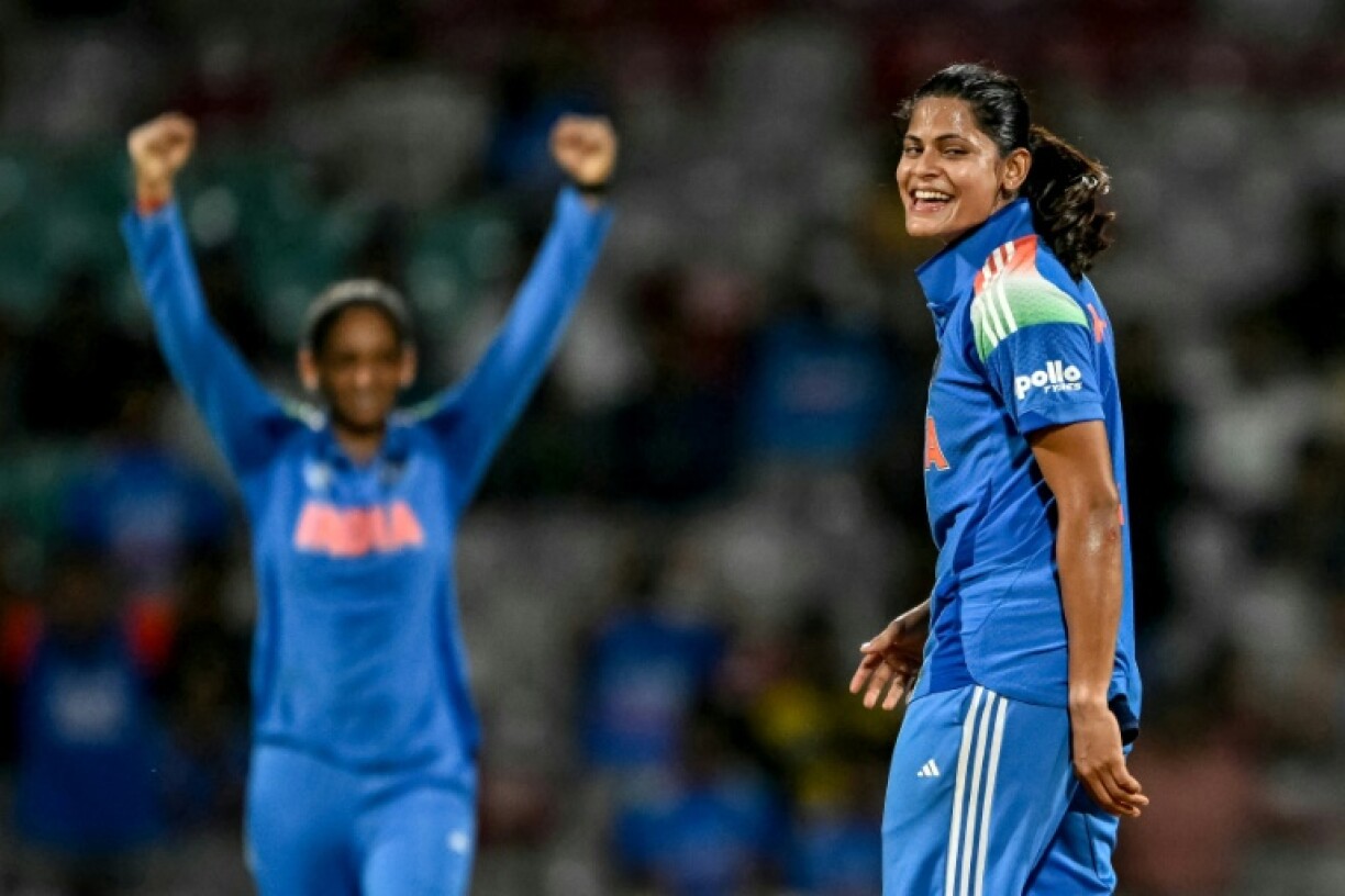 India's Radha Yadav (R) celebrates after taking a wicket at the World Cup