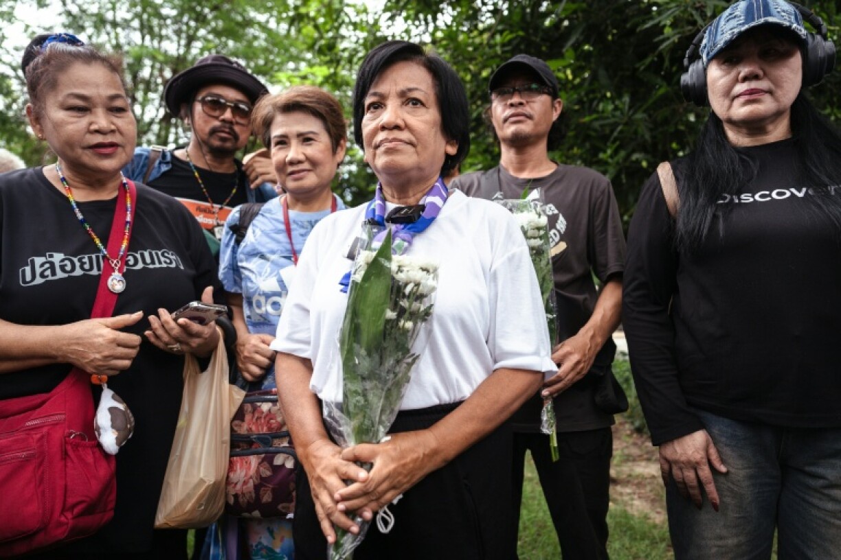 Anchan Preelert (C) was initially sentenced to 87 years under Thailand's lese-majeste law but the court halved it because she confessed