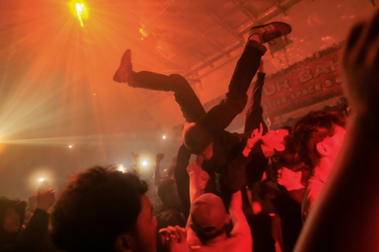 At a smoke-filled warehouse in Jakarta hundreds of Indonesians party to the sounds of 1990s Britain