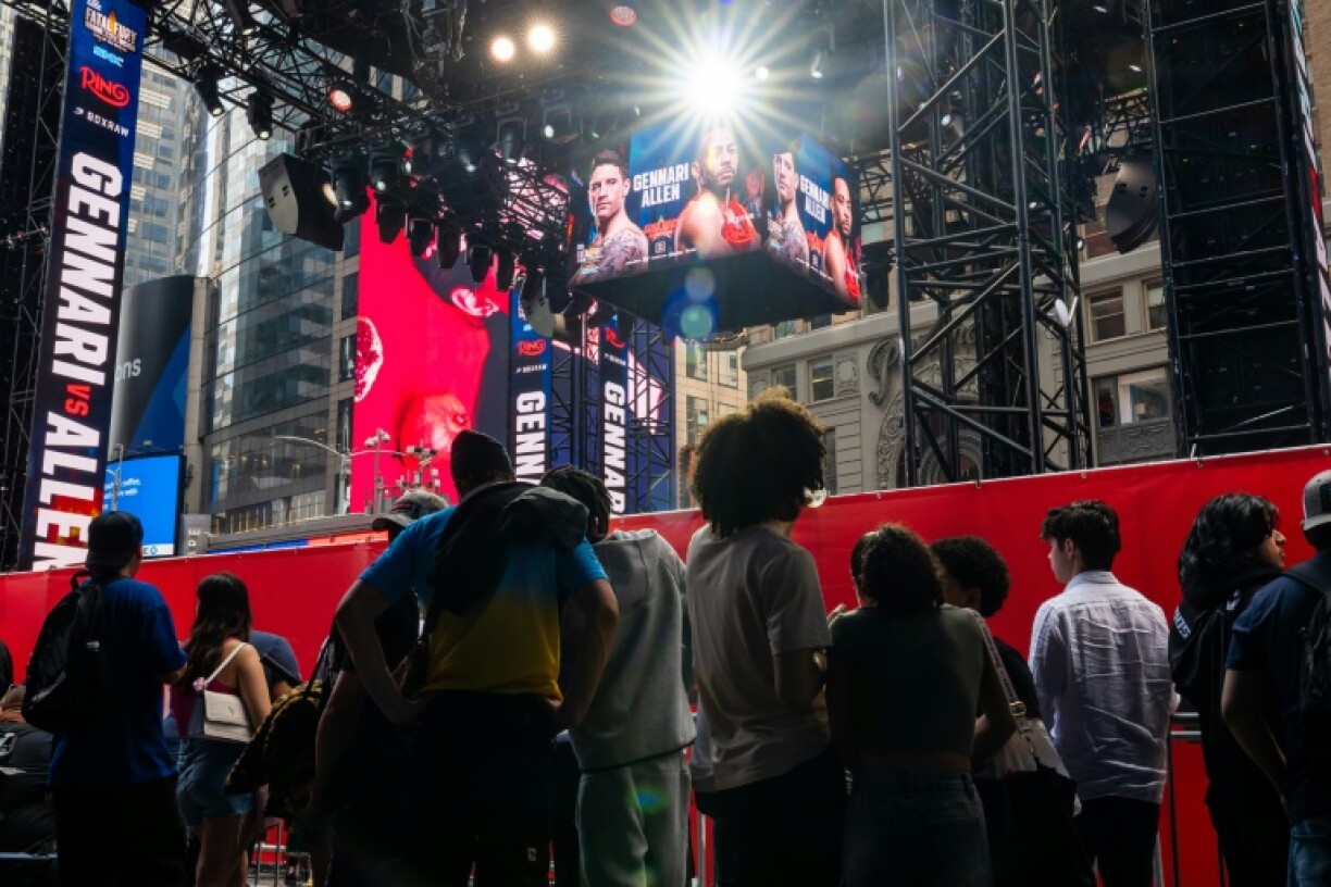 People gather around the outdoor boxing ring erected in Times Square for the fight card featuring Ryan Garcia's return from a doping suspension