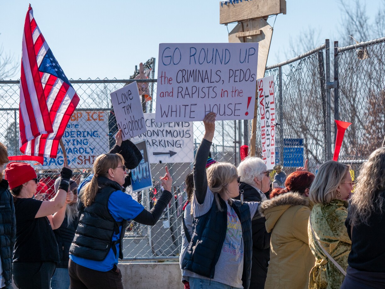 Demonstrante virum Bishop Whipple Federal Building, wou ICE Leit, déi si matgeholl hunn, festhält.