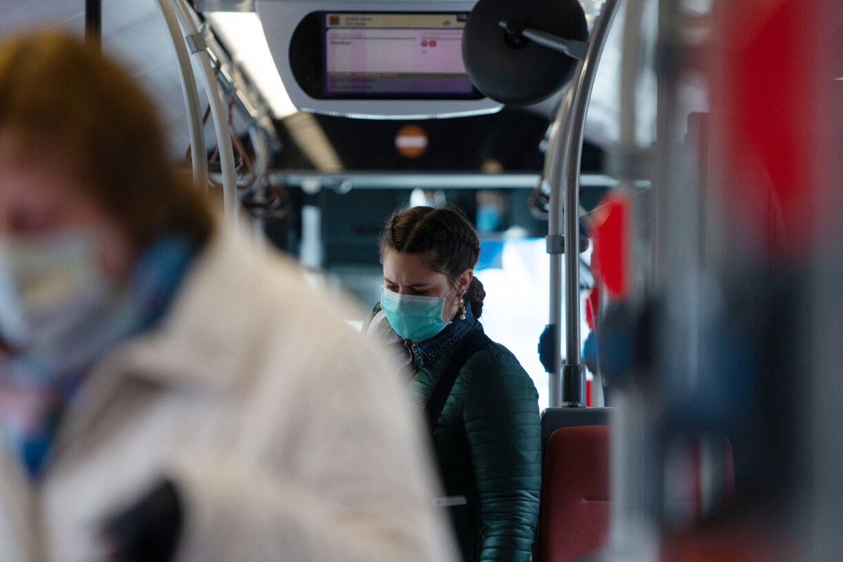 File photo. A woman wears a mask on a bus in Belgium.