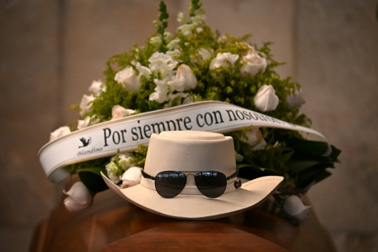 Rubby Perez's trademark hat and sunglasses topped his coffin