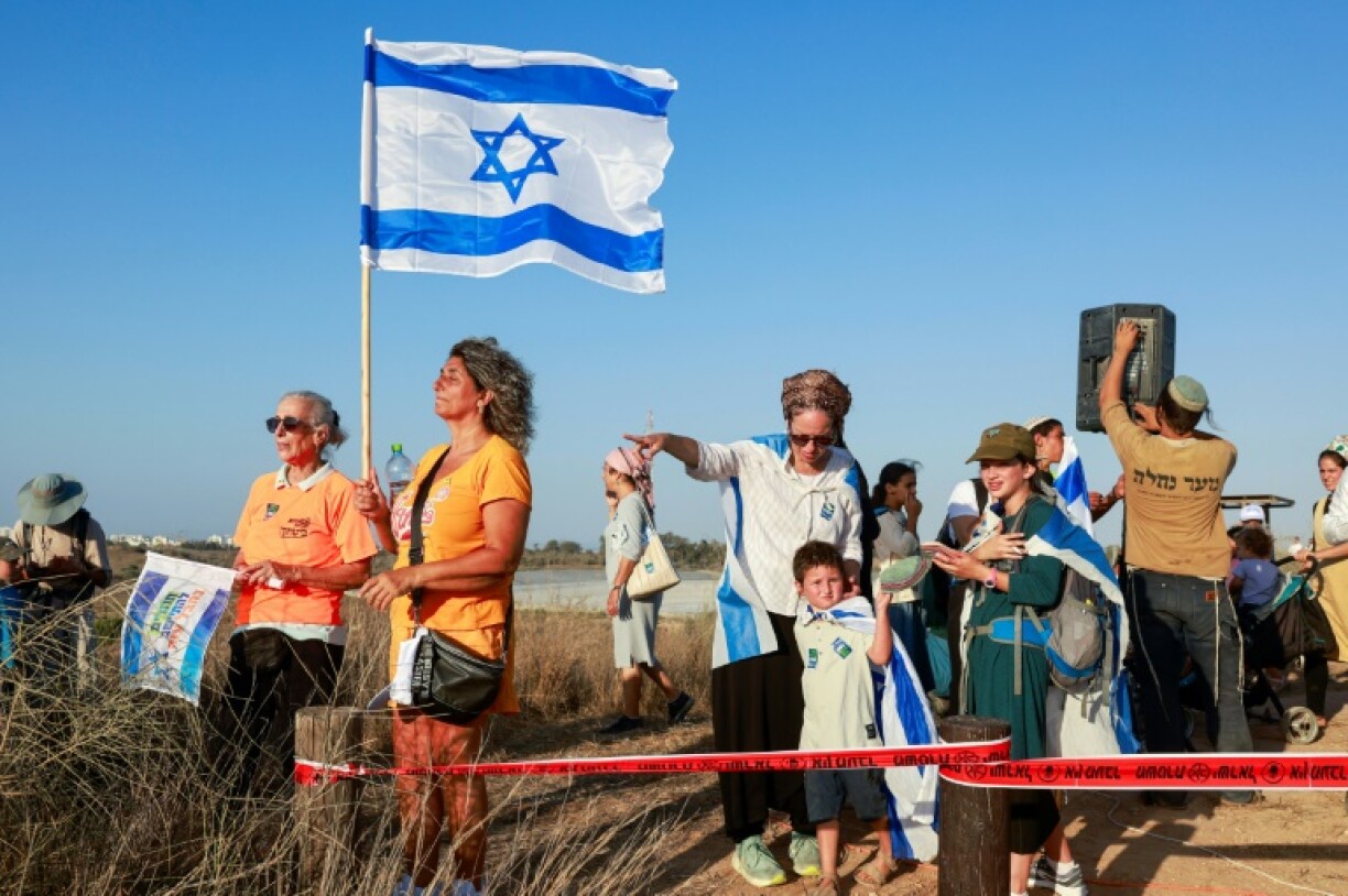 Israeli right-wing protesters gather on a hill overlooking Gaza to call for the re-occupation of the territory