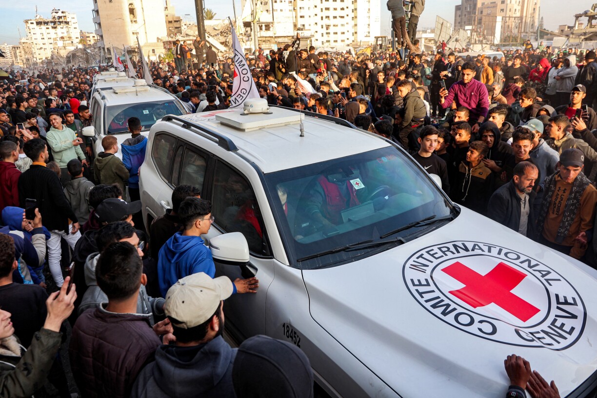People gather around a vehicle of the International Committee of the Red Cross (ICRC) in Saraya Square in western Gaza City on January 19, 2025.