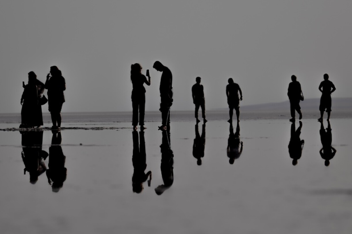 Tourists can walk along the surface of Tuz Golu salt lake in Turkey as water levels have hit a crisis low