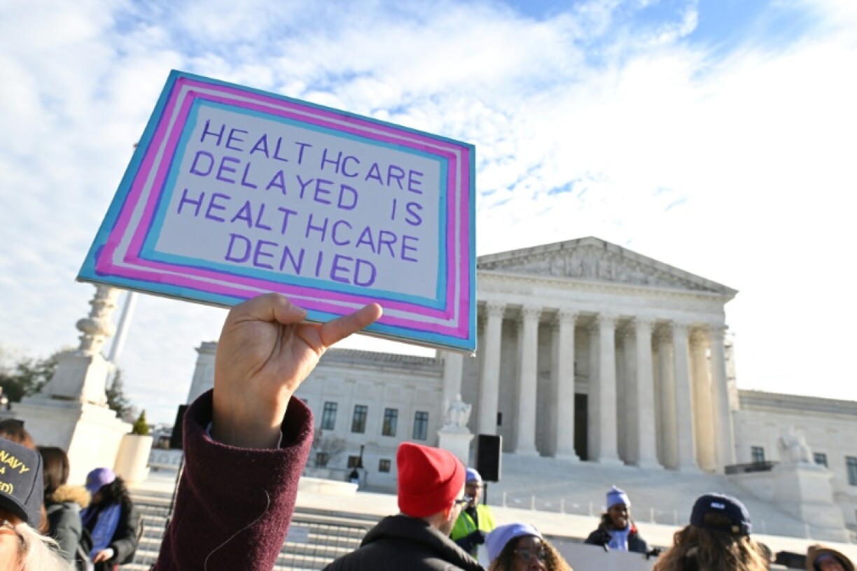 Demonstrators outside the US Supreme Court during oral arguments about a Tennessee law banning gender transition medical treatments for minors