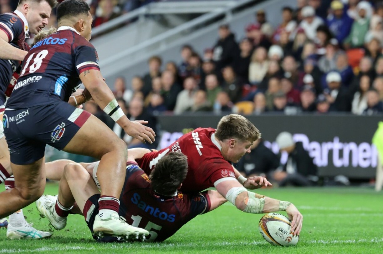 British and Irish Lions wing Tommy Freeman scores one of his two tries against Queensland Reds