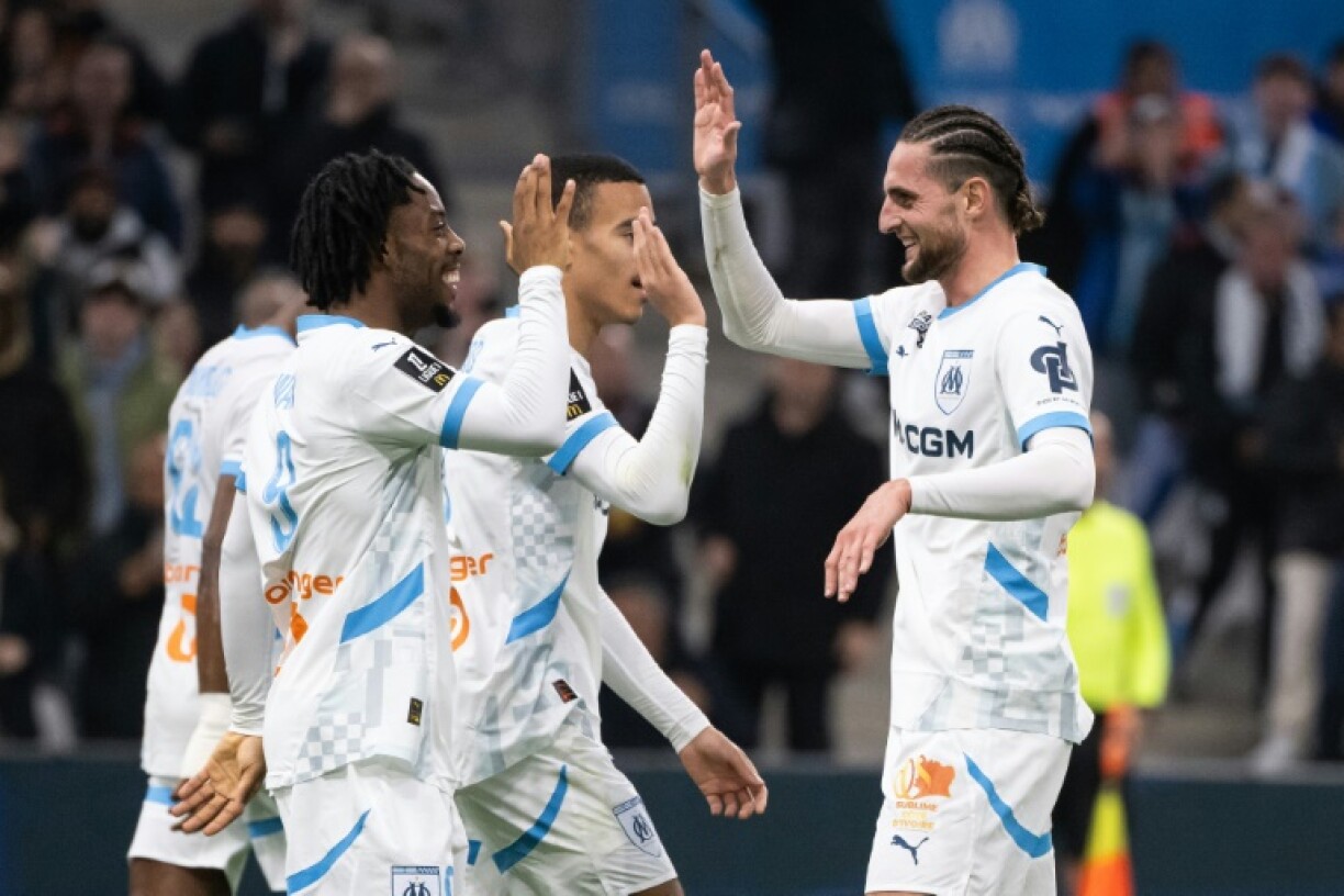 Elye Wahi (L) celebrates with Adrien Rabiot after scoring Marseille's fourth goal in their 5-1 demolition of Le Havre on Sunday