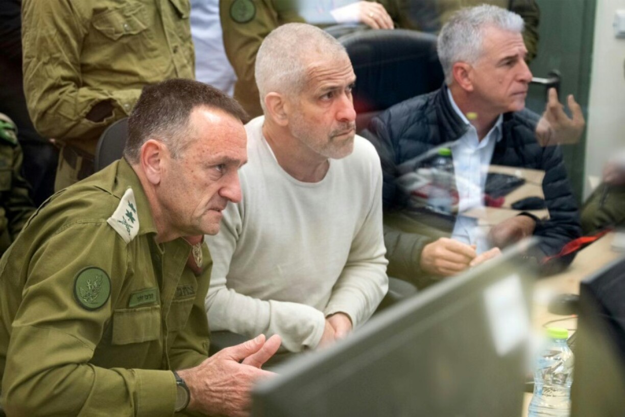 Shin Bet chief Ronen Bar (C) monitors the return of hostages from Gaza on January 25, 2025, with Israeli army Chief of the General Staff Lieutenant-General Herzi Halevi (L) and Israeli intelligence agency Mossad director David Barnea (R)