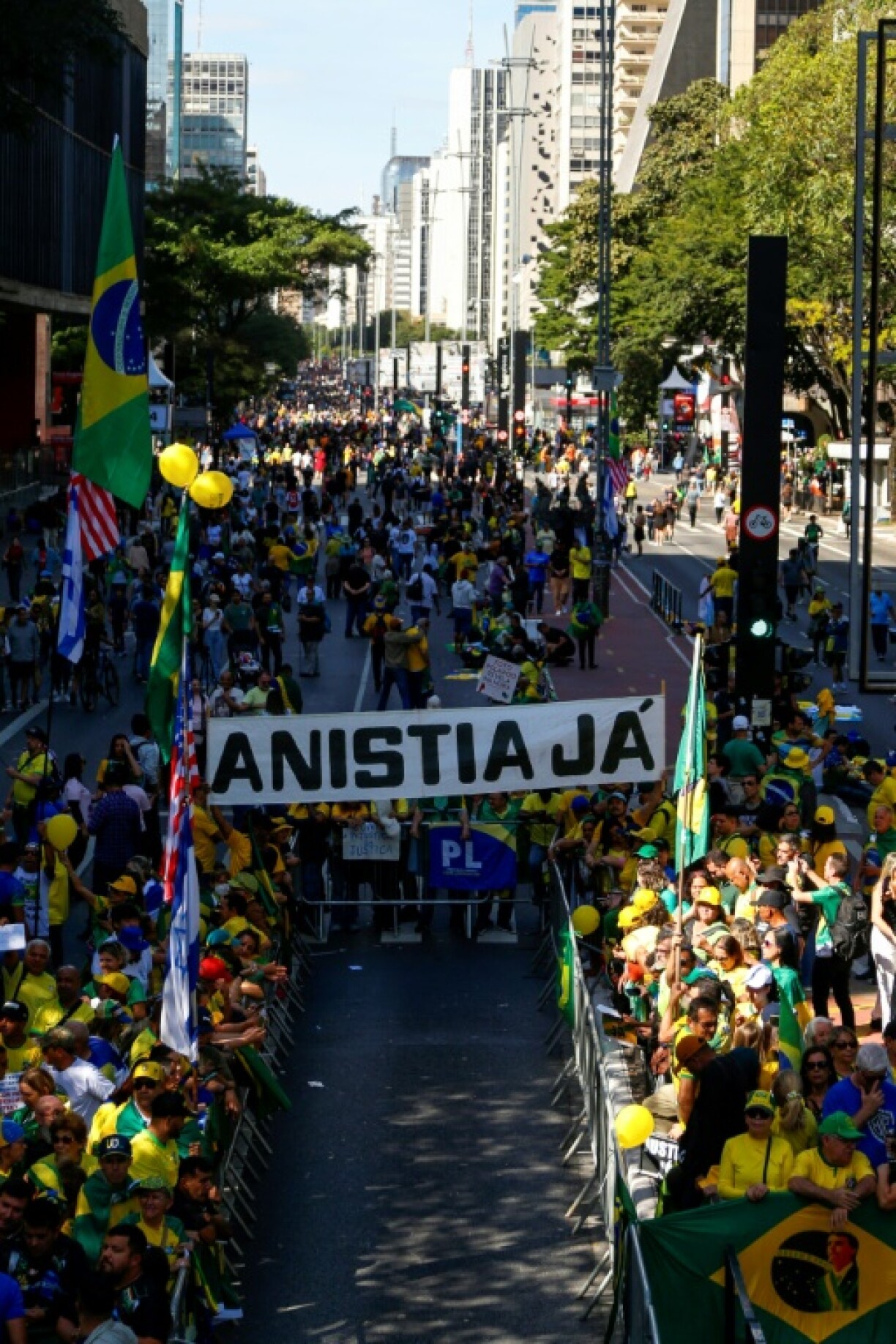 Supporters of Brazil's ex-president Jair Bolsonaro hold a banner reading 'Amnesty now' during a rally in Sao Paulo in support of the embattled former leader