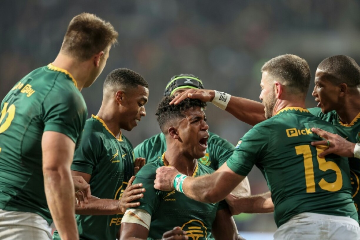 South Africa centre Canan Moodie (C) is congratulated after scoring a try against Italy.