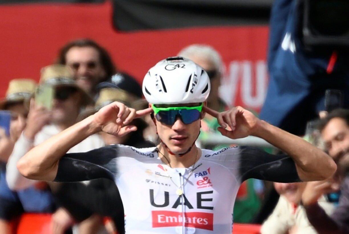 Team UAE's Spanish rider Juan Ayuso gestures as he celebrates winning stage seven of La Vuelta on Friday