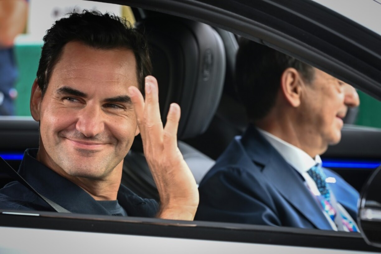 Roger Federer (L) on his way to start the Le Mans 24 Hours