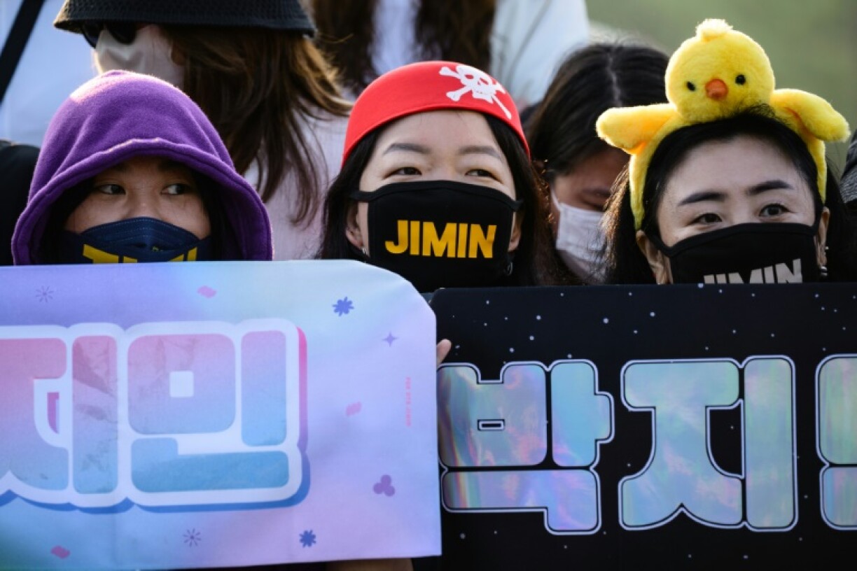 Fans of K-pop boy band BTS wait for members Jimin and Jungkook at an outdoor sporting facility in Yeoncheon