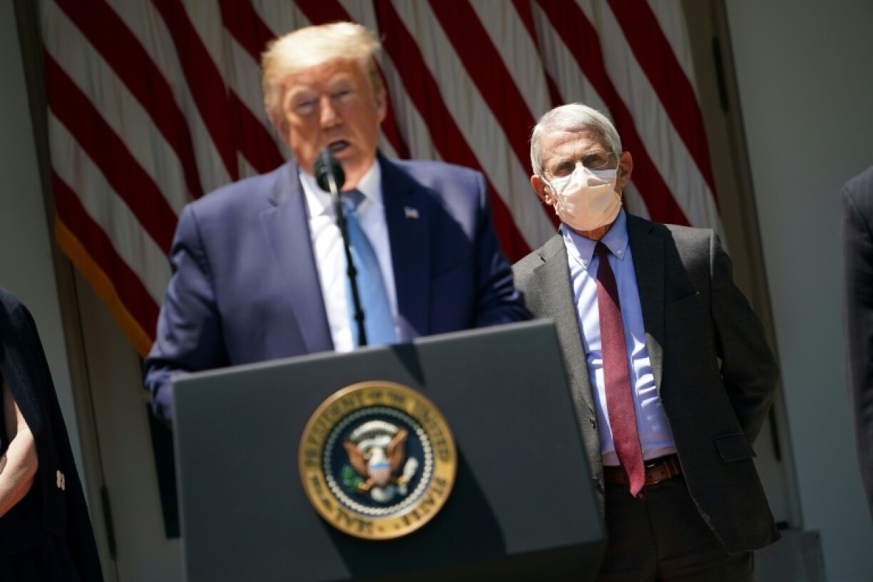 Donald Trump and government scientist Anthony Fauci (R) clashed over the response to the pandemic