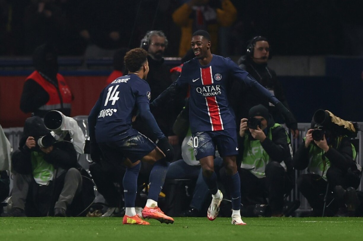 Ousmane Dembele (R) celebrates with Desire Doue after scoring his first goal and PSG's third against Monaco on Friday