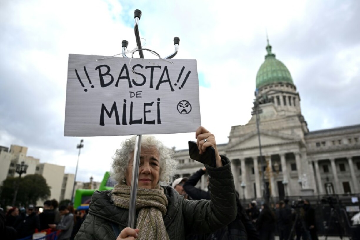 A woman holds a sign that reads in