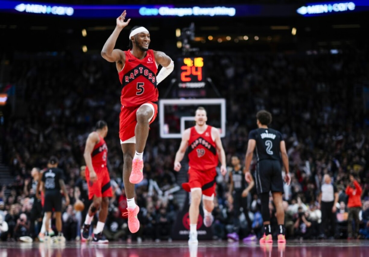 Immanuel Quickley of the Toronto Raptors celebrates a three-point basket in an NBA victory over the Brooklyn Nets