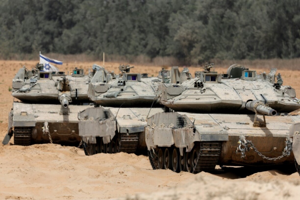 Israeli troops deployed at the border with the Gaza Strip on Tuesday, as the military announced it had expanded its campaign in the territory