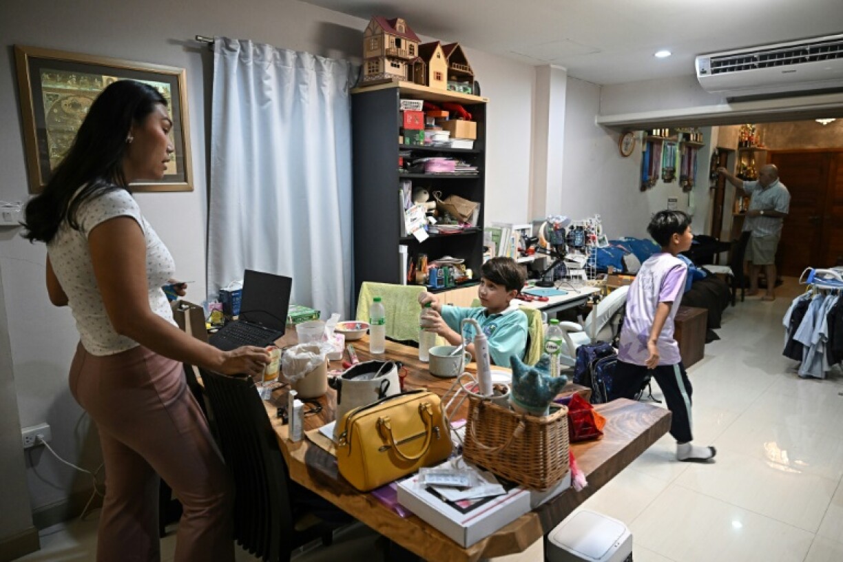 The couple and their two sons share a home in a Bangkok suburb, filled with family photos, chickens, and two parrots