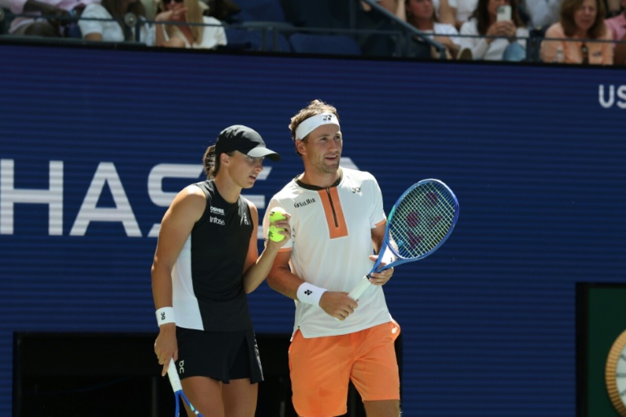 Norway's Casper Ruud (right) and Poland's Iga Swiatek huddle during their US Open mixed doubles victory