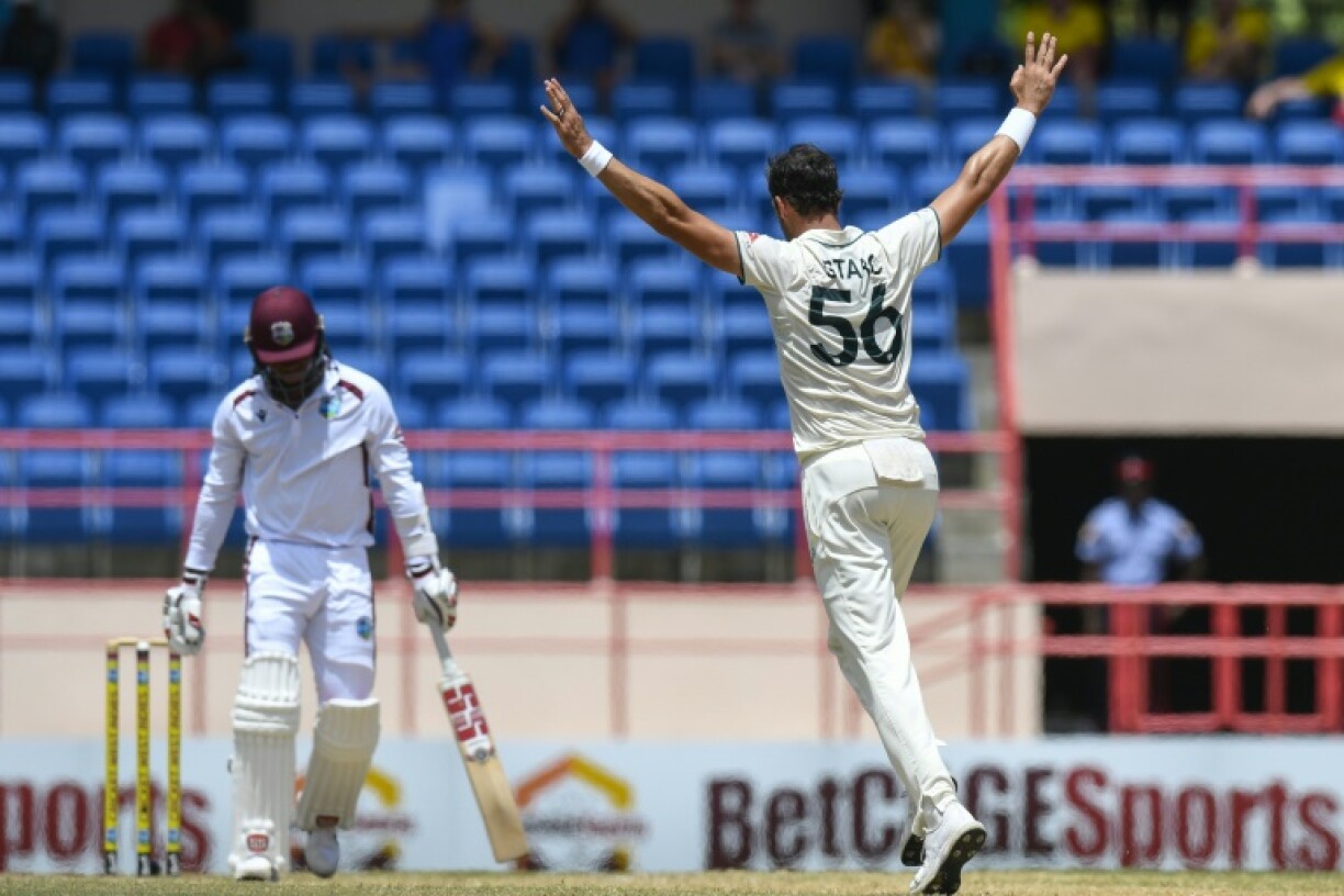 Mitchell Starc (R) celebrates dismissing Keacy Carty