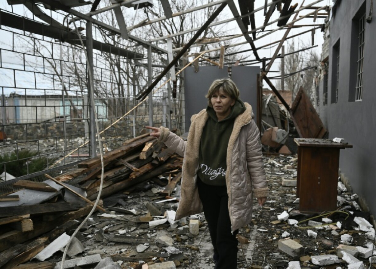 Svitlana Rudokvas, 51, shows a destroyed restaurant in the heavily village of Novopavlivka